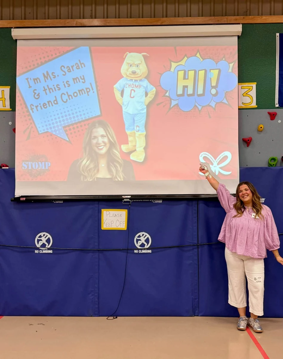 STOMP presenter beside the welcome screen at Boyd Elementary
