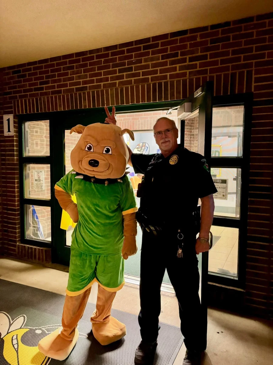 CHOMP mascot posing with an officer at Boyd Elementary
