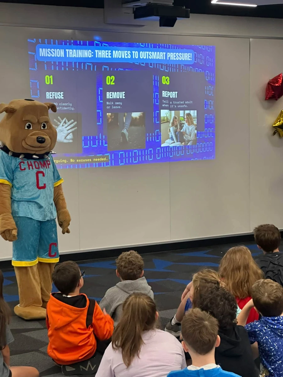 CHOMP mascot beside the presentation screen